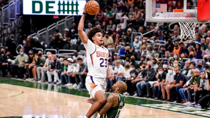 Suns' Cam Johnson dunks on Bucks' forward PJ Tucker